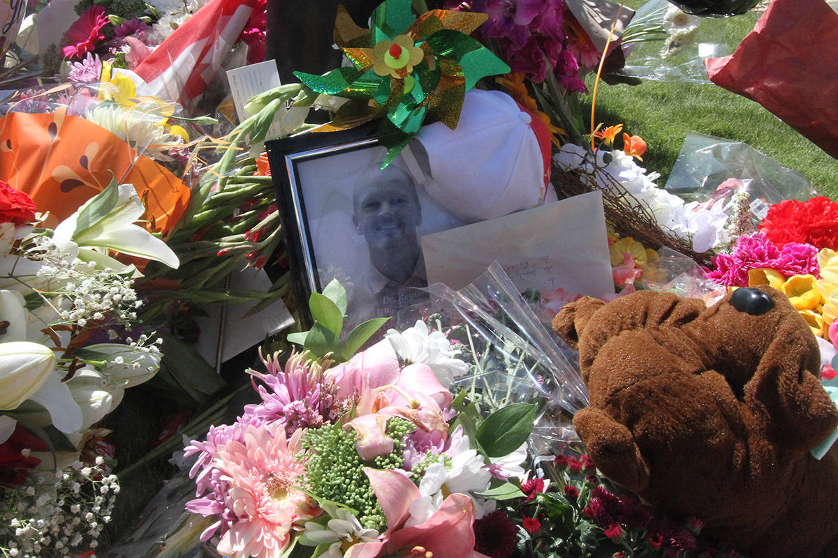 Dozens of bouquets of flowers, stuffed animals and other messages of gratitude and condolence have been left outside the walk-in clinic where Dr. Walter Reynolds was murdered on Monday. Photo by PAUL COWLEY/Advocate staff