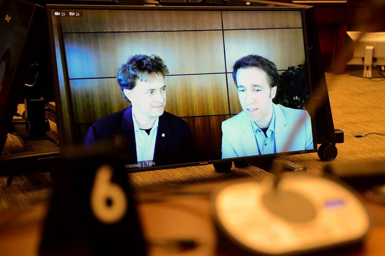 Marc Kielburger, screen left, and Craig Kielburger, screen right, appear as witnesses via videoconference during a House of Commons finance committee in the Wellington Building in Ottawa on Tuesday, July 28, 2020. THE CANADIAN PRESS/Sean Kilpatrick