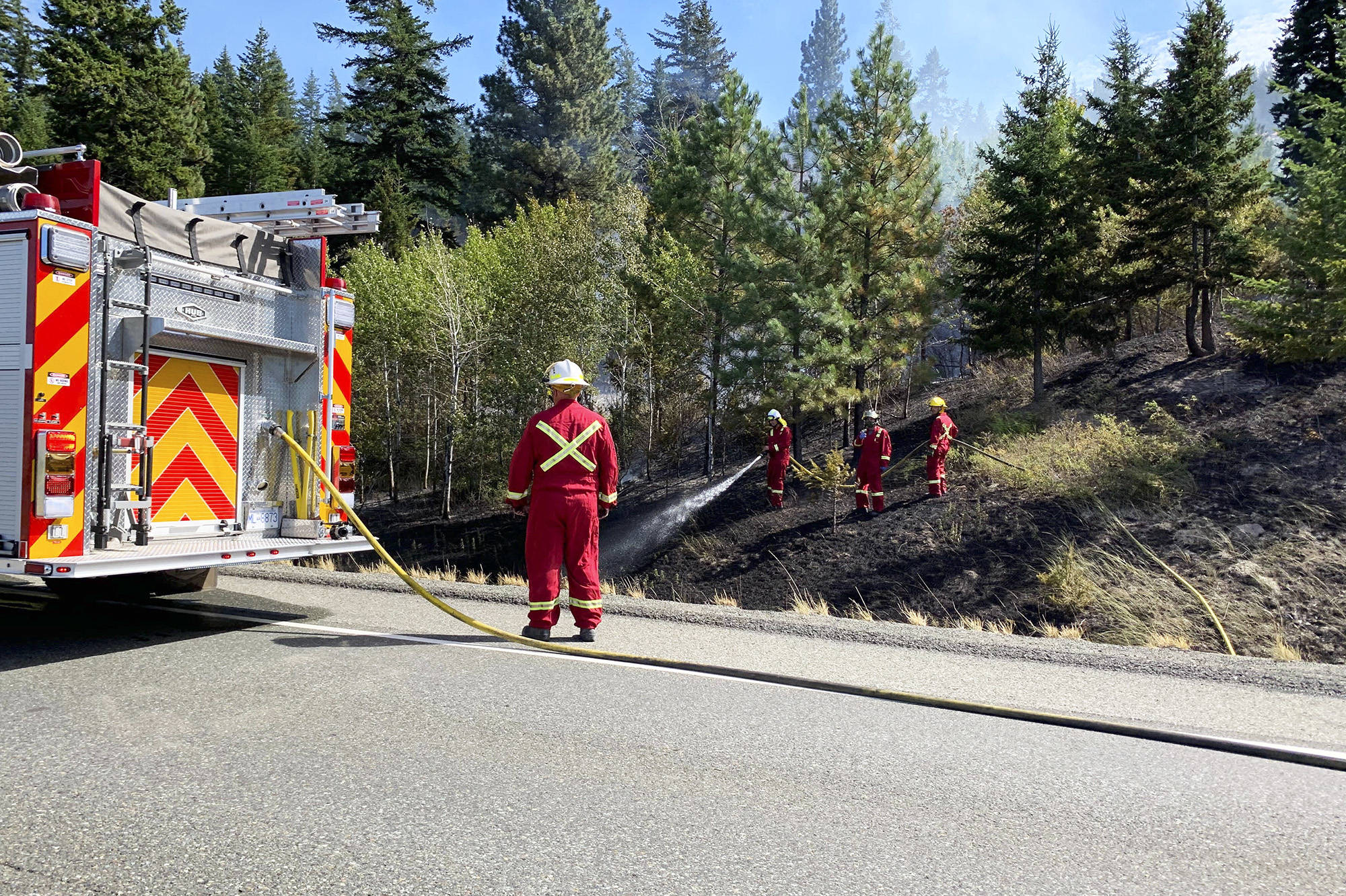 Fire crews from Merritt rushed to extinguish a fire by the Coquihalla Highway on Aug. 22 (Christian Peters Photo)