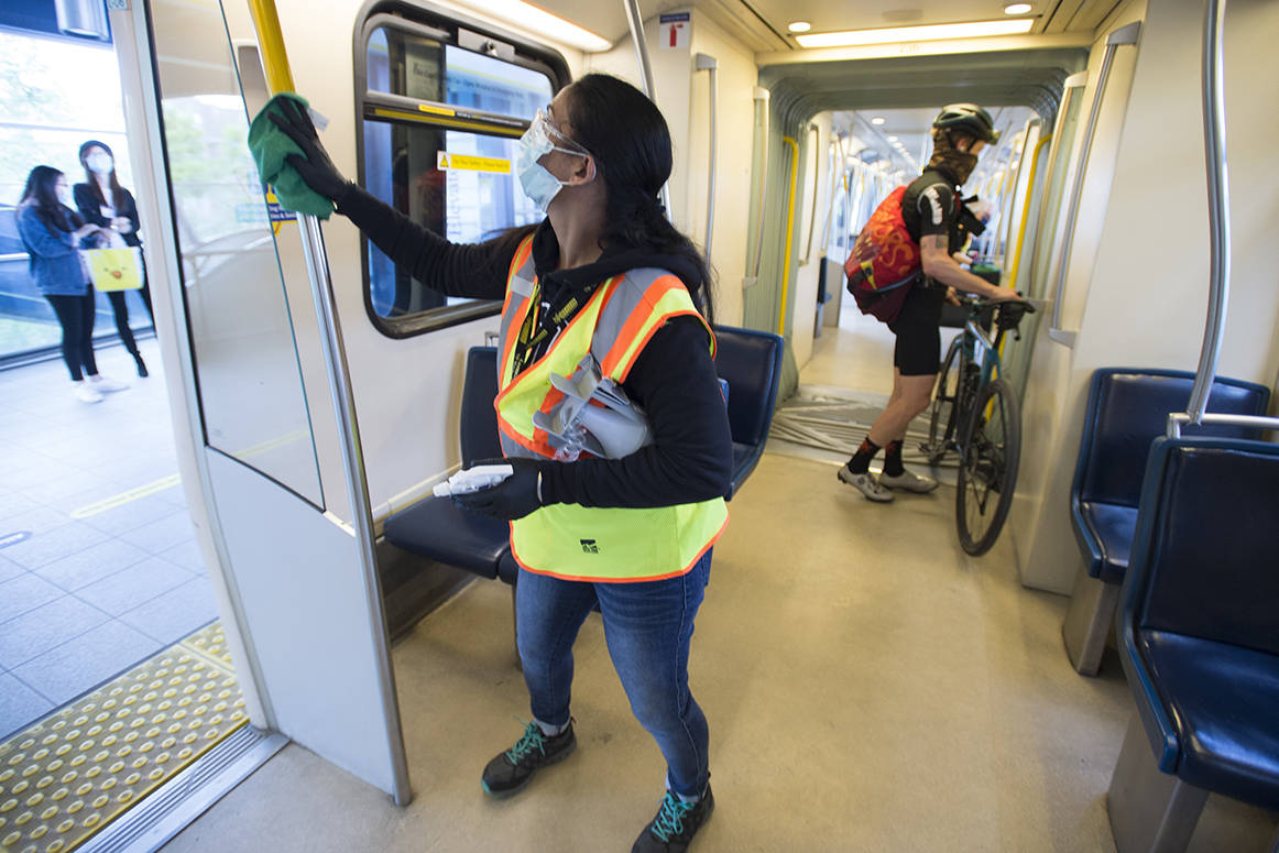 A cleaner demonstrates how they disinfect the train cars of the Sky Train in Vancouver, Thursday, May 21, 2020. Translink is working to try and provide a safe riding environment for their passengers during the COVID-19 pandemic. THE CANADIAN PRESS/Jonathan Hayward