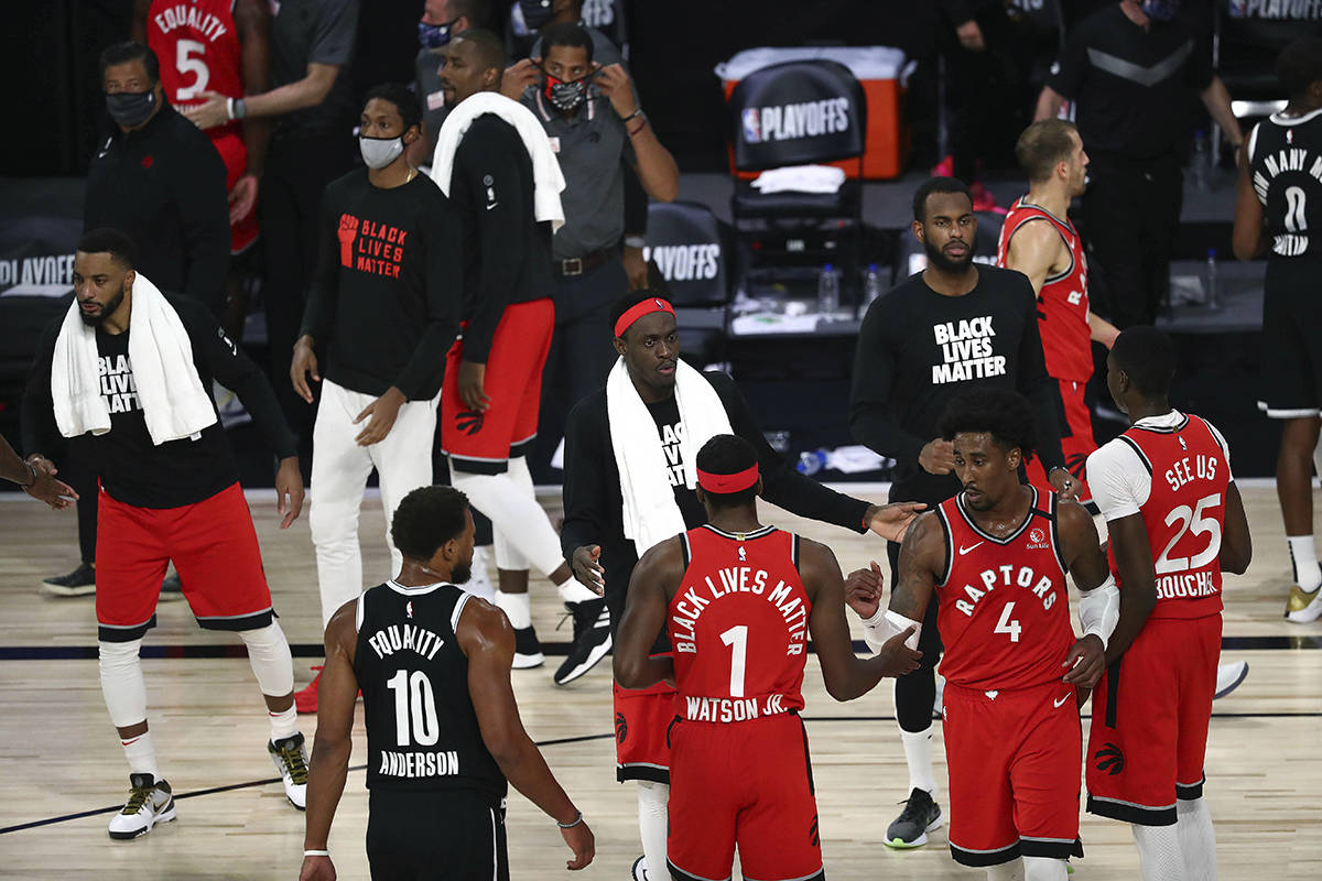 Toronto Raptors forward Pascal Siakam (43) and the Raptors celebrate the game and series victory against the Brooklyn Nets following Game 4 of an NBA basketball first-round playoff series, Sunday, Aug. 23, 2020, in Lake Buena Vista, Fla. THE CANADIAN PRESS/Kim Klement/Pool Photo via AP
