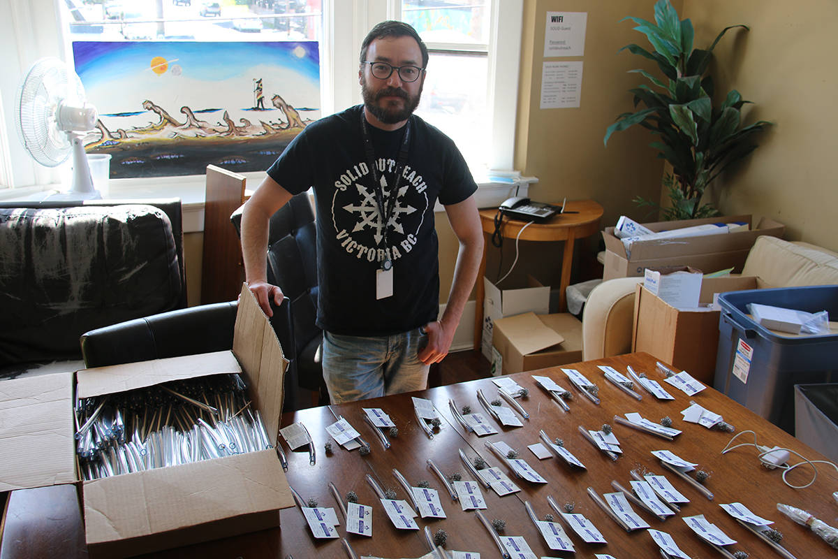 Fred Cameron with SOLID Outreach stands among the harm reduction supplies handed out by the group. The organization is asking the city for a three-year temporary use permit that would allow them to distribute cannabis for free as a harm reduction service. (Kendra Crighton/News Staff)