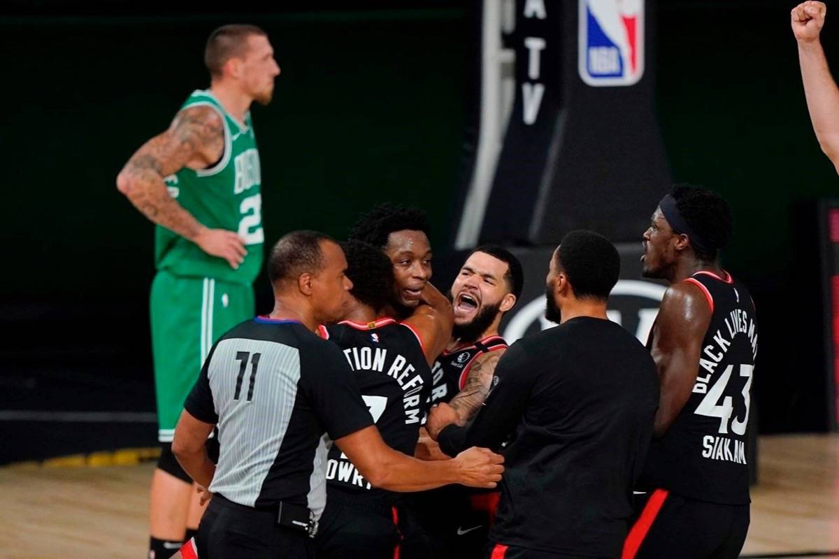 Teammates mob Toronto Raptors’ OG Anunoby, second player from left, after Anunoby’s game winning shot at the buzzer in the second half of an NBA conference semifinal playoff basketball game against the Boston Celtics Thursday, Sept 3, 2020, in Lake Buena Vista Fla. Celtic’s Daniel Theis is at rear. THE CANADIAN PRESS/AP-Mark J. Terrill