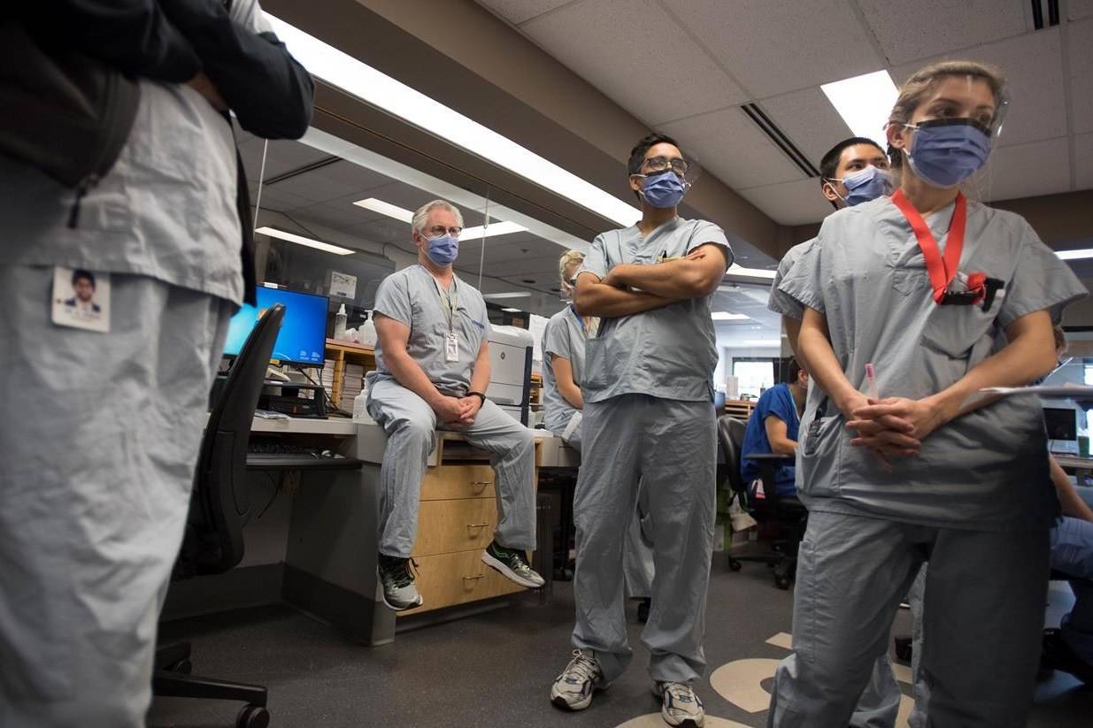 Dr. Del Dorscheid, centre, takes part in board rounds in the COVID-19 intensive care unit at St. Paul’s hospital in downtown Vancouver on April 21, 2020. Canadians appear to still have solid faith in doctors and scientists nearly six months into the COVID-19 pandemic. A new survey done for Proof Strategies over the Labour Day weekend suggests more than eight in 10 Canadians trust doctors and almost eight in 10 trust scientists. THE CANADIAN PRESS/Jonathan Hayward