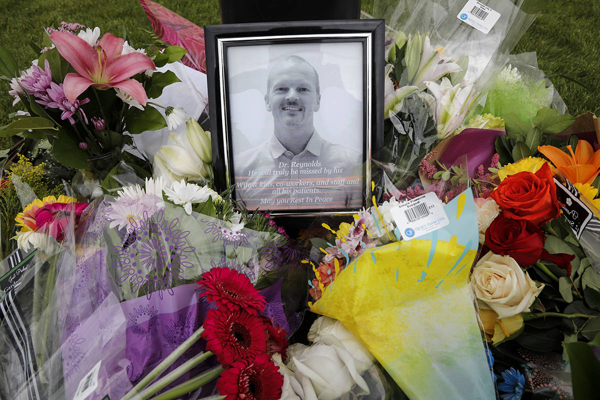 An impromptu memorial for Dr. Walter Reynolds, who died after he was attacked in an examination room rests outside the Village Mall walk-in clinic in Red Deer, Alta., on August 11, 2020. A man accused of killing a family doctor at a medical clinic in central Alberta is scheduled to appear in court today. Deng Mabiour is charged with first-degree murder in death of Dr. Walter Reynolds. THE CANADIAN PRESS/Jeff McIntosh