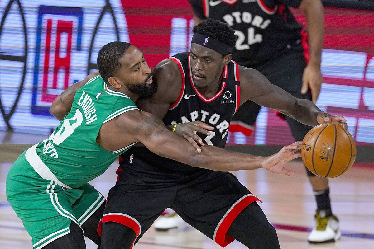 Toronto Raptors forward Pascal Siakam (43) drives on Boston Celtics guard Kemba Walker (8) during the second half of an NBA conference semifinal playoff basketball game Wednesday, Sept. 9, 2020, in Lake Buena Vista, Fla. (AP Photo/Mark J. Terrill)