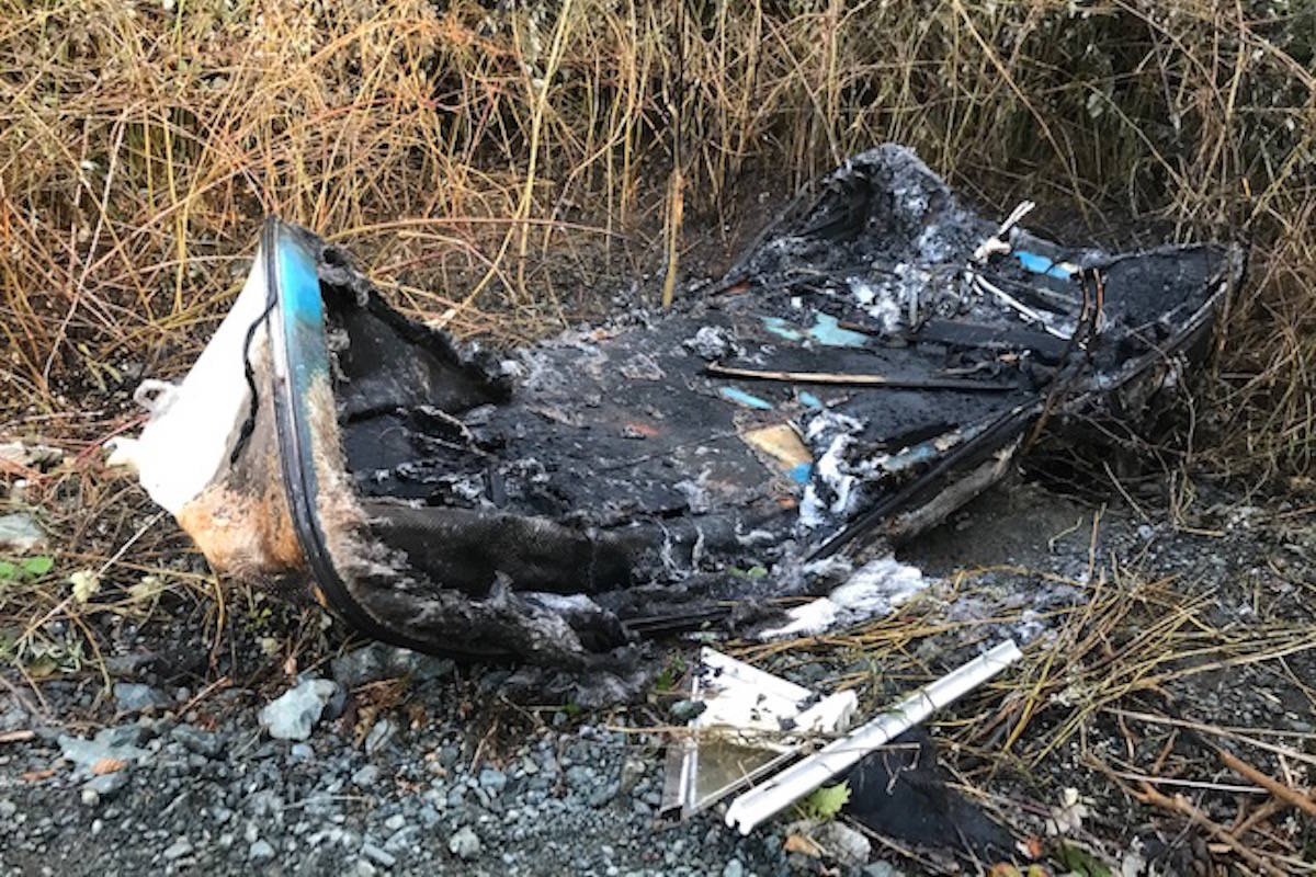 A fire that ignited near the intersection of Drennan Street and Sooke Road in Sooke left the remains of a charred boat Wednesday night. (Joan Stiebel photo)