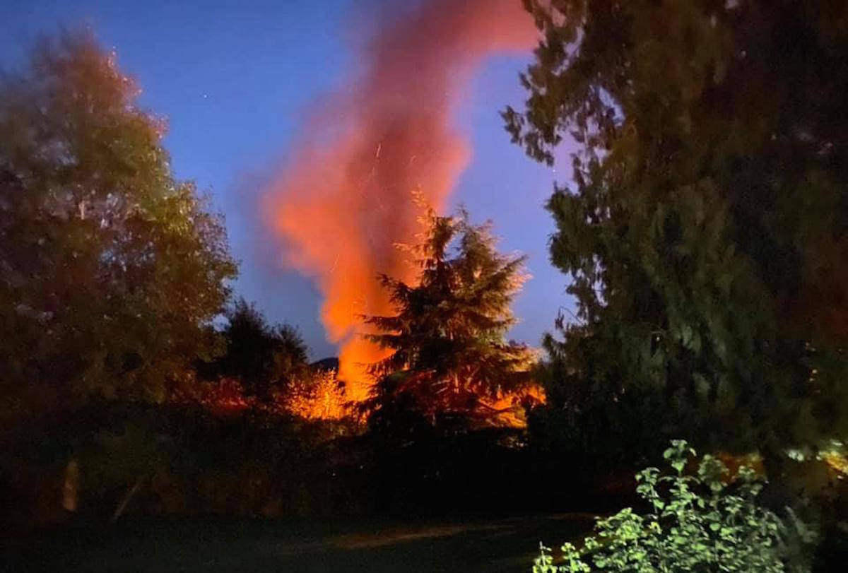 A fire that ignited near the intersection of Drennan Street and Sooke Road in Sooke left the remains of a charred boat Wednesday night. (Paige Haire photo)