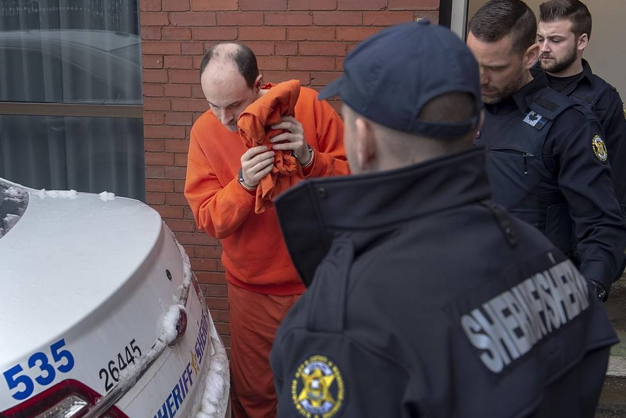 Matthew Raymond is taken from Court of Queen’s Bench in Fredericton on Friday, March 13, 2020. The trial begins today for a Fredericton man charged in the fatal shootings of four people in the New Brunswick capital more than two years ago. THE CANADIAN PRESS/Andrew Vaughan
