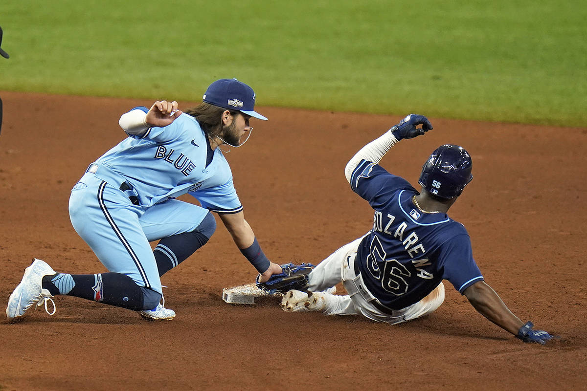 Toronto Blue Jays shortstop Bo Bichette tags out Tampa Bay Rays’ Randy Arozarena (56) as he gets caught attempting to steal second base during the sixth inning of Game 2 of an American League wild-card baseball series Wednesday, Sept. 30, 2020, in St. Petersburg, Fla. (AP Photo/Chris O’Meara)