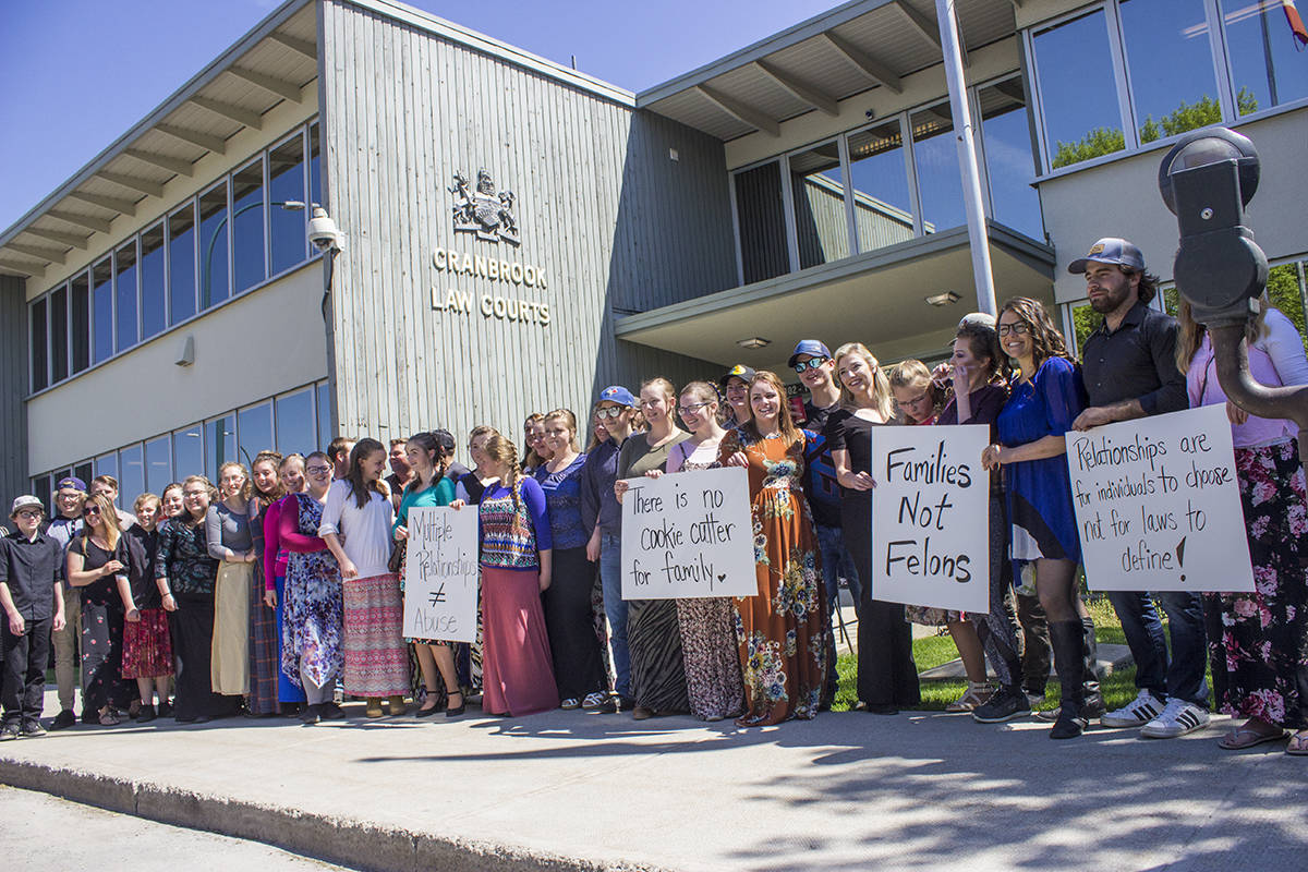 Winston Blackmore’s family gathers outside the Cranbrook Law Courts on May 15, 2018, the day of his sentencing, with signs illustrating their support. Paul Rodgers photo