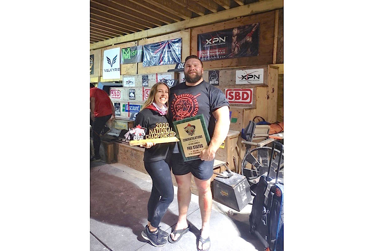 Sean Hayes displays the trophy and pro circuit plaque after winning Strongman Nationals in Quebec City. At left is his girlfriend, Kayla Russman-Walberg. Photo supplied
