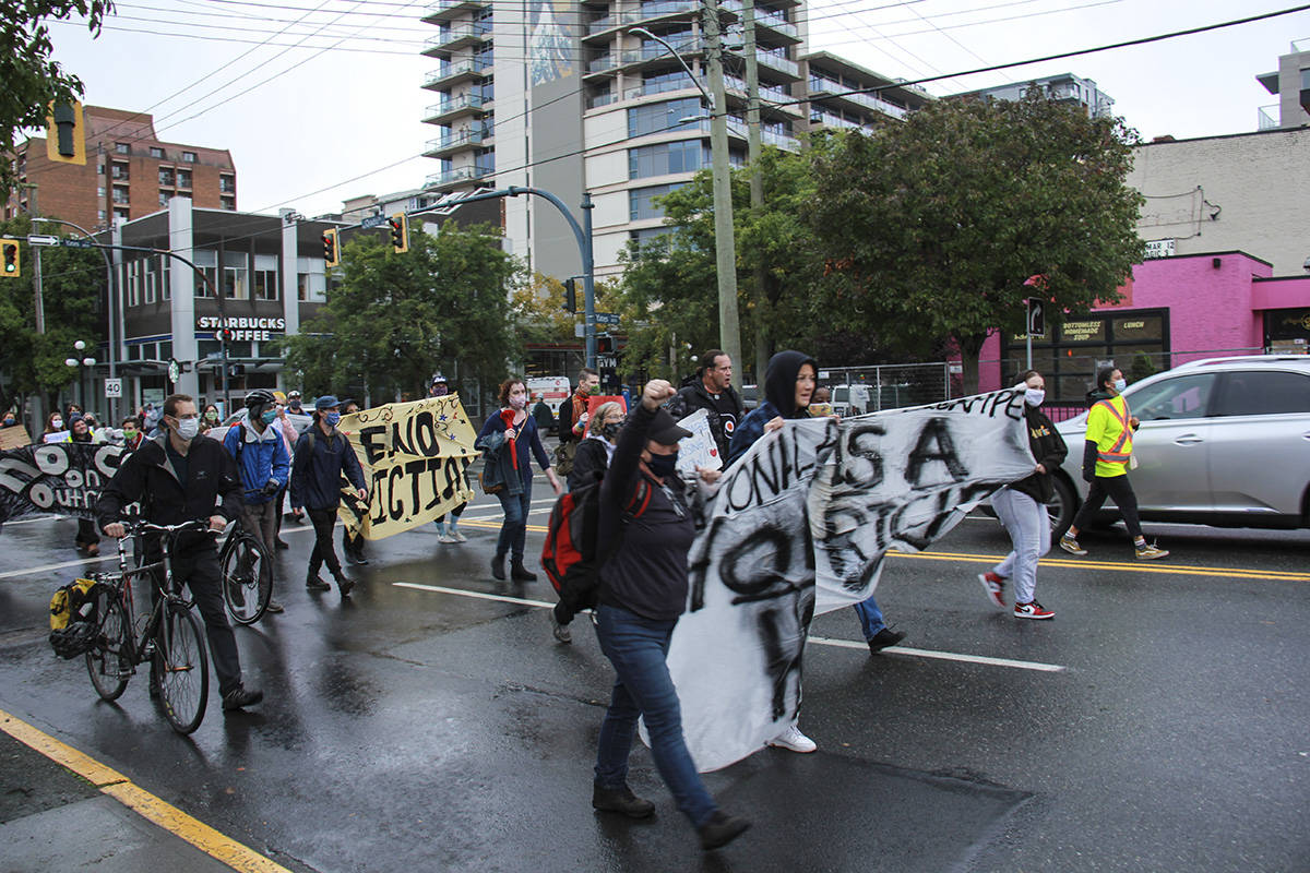 A few dozen residents marched through the streets of Downtown Victoria Oct. 16, calling for affordable and safe housing for all. (Jane Skrypnek/News Staff)