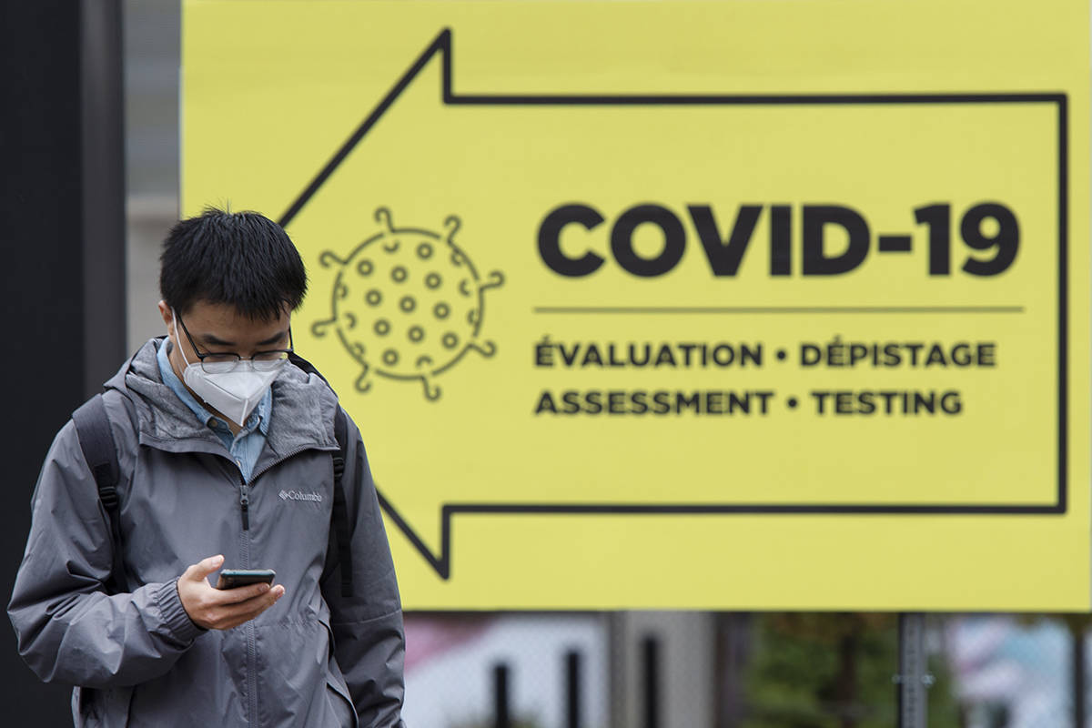 A passer-by walks past a COVID-19 testing clinic in Montreal, Friday, Oct. 16, 2020. THE CANADIAN PRESS/Ryan Remiorz