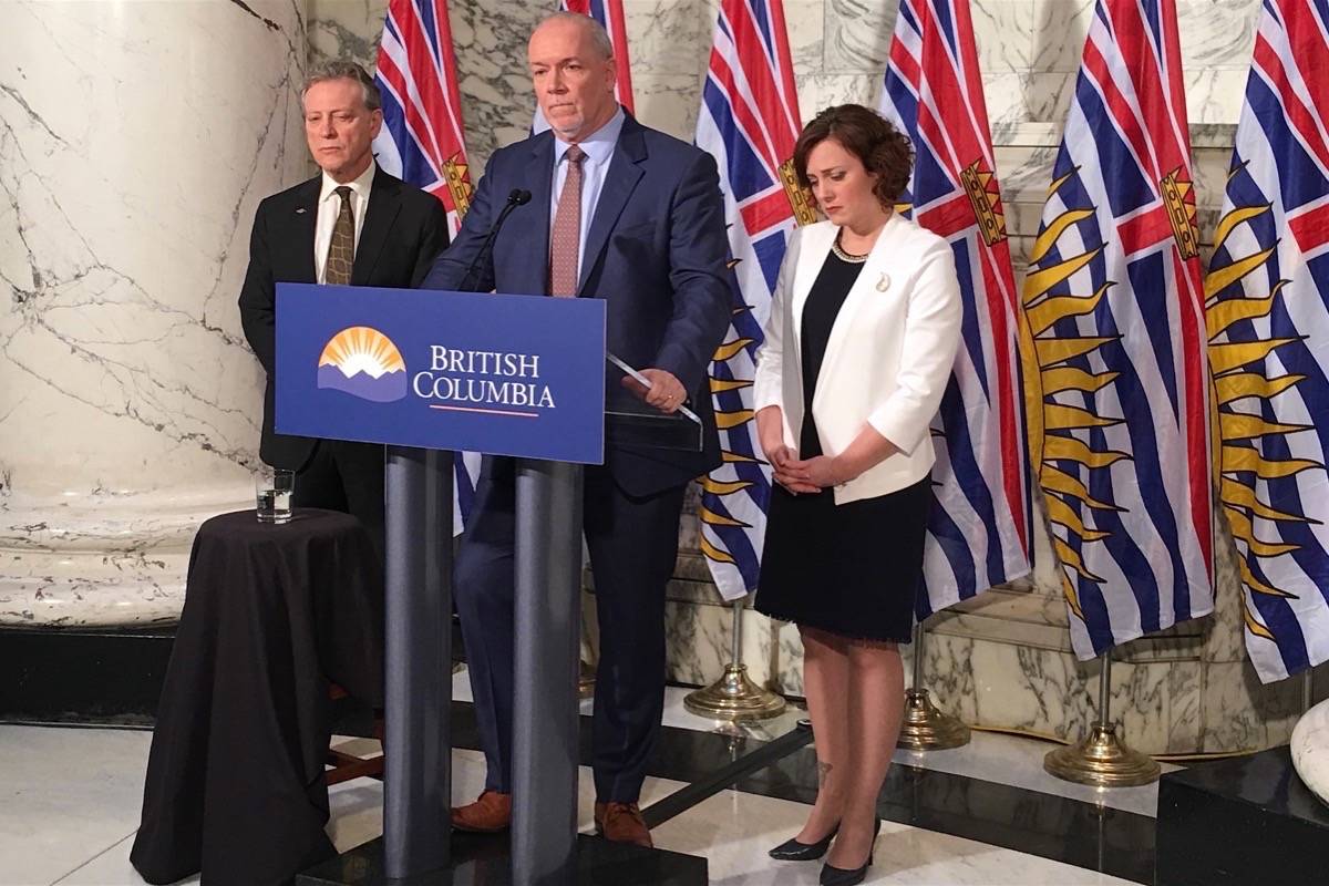 Environment Minister George Heyman, Premier John Horgan and Energy Minister Michelle Mungall announce that B.C. Hydro is proceeding with construction of the Site C dam, Dec. 11, 2017. (Tom Fletcher/Black Press)