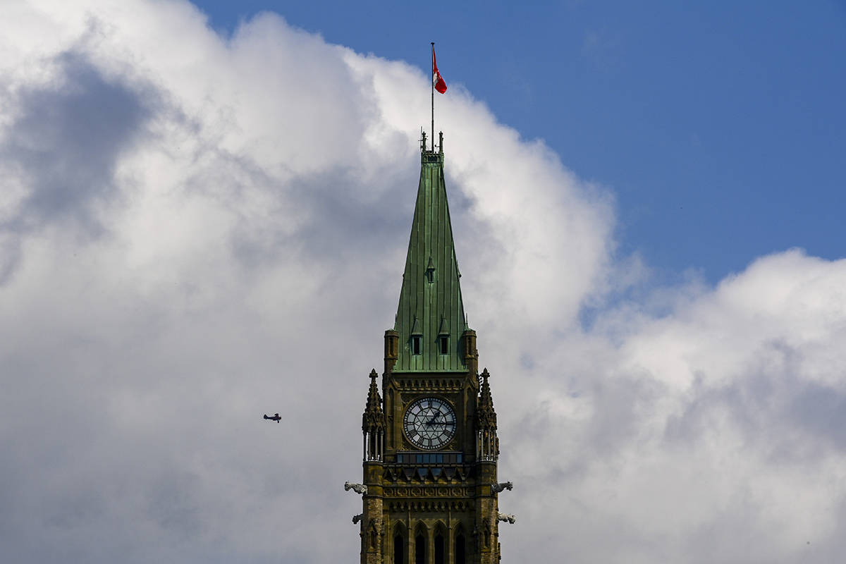 A small tourist plane passes over downtown Ottawa at Parliament Hill on Monday, Aug. 24, 2020. THE CANADIAN PRESS/Sean Kilpatrick