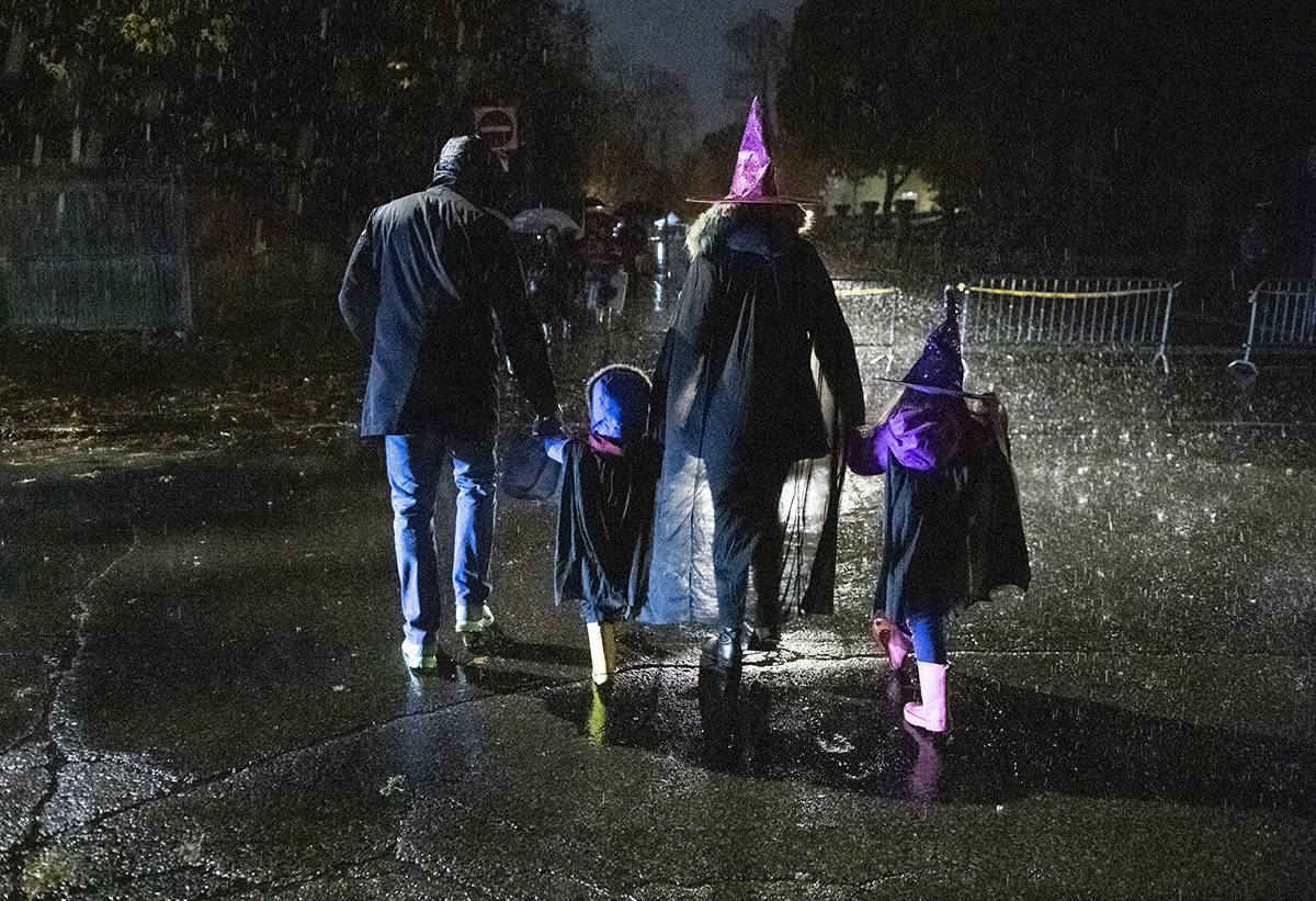 FILE – People go trick or treating in the rain on Halloween in Ottawa, on Thursday, Oct. 31, 2019. THE CANADIAN PRESS/Justin Tang