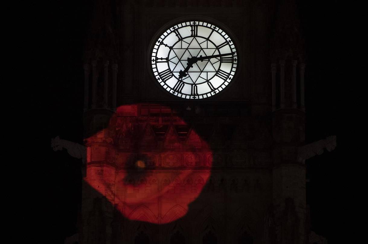 A poppy is projected on the side of the Peace Tower in Ottawa, Monday, Nov. 9, 2020. On the eve of Remembrance Day, the federal Liberal government is moving ahead with plans to provide emergency assistance to veterans organizations that have been battered by the COVID-19 pandemic. THE CANADIAN PRESS/Adrian Wyld
