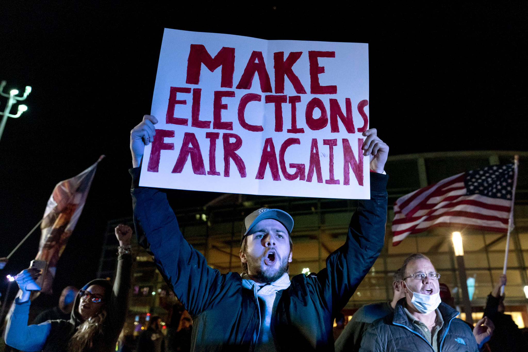 Trump supporter Jake Contos chants during a protest against the election results outside the central counting board at the tcf Center in Detroit, Thursday, Nov. 5, 2020. (AP Photo/David Goldman)