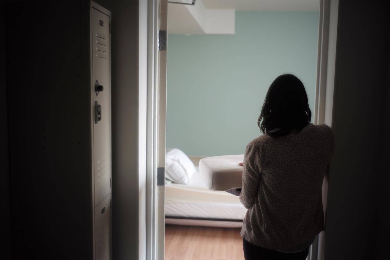A staff member carries bedding in one of the suites at Toronto’s Interval House, an emergency shelter for women in abusive situations, on Monday February 6, 2017. A new national survey by Women’s Shelters Canada offers a glimpse into the experiences of front-line workers and women fleeing violence during the COVID-19 pandemic, with reports of clients facing more violence that is also increasing in severity. THE CANADIAN PRESS/Chris Young