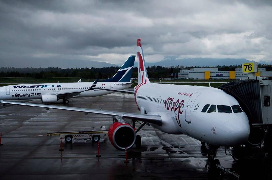 A Westjet Boeing 737-800, left, taxis past an Air Canada Rouge Airbus A319 at Vancouver International Airport in Richmond, B.C., on Monday, April 28, 2014. Consumer rights advocates are criticizing the latest statement on airline refunds from the country’s transport regulator, saying it contradicts federal and provincial law to the detriment of customers. THE CANADIAN PRESS/Darryl Dyck