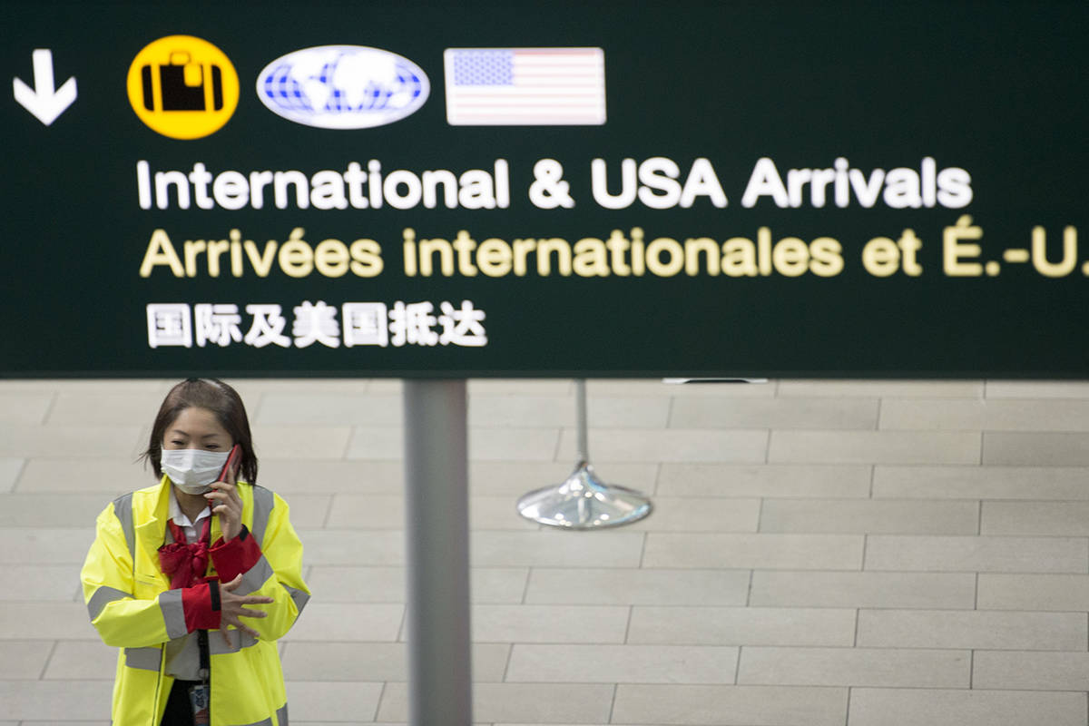 A airport worker is pictured at Vancouver International Airport in Richmond, B.C. Wednesday, March 18, 2020. THE CANADIAN PRESS/Jonathan Hayward
