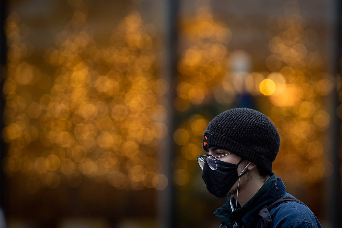 A man wearing a face mask to help curb the spread of COVID-19 walks in downtown Vancouver, B.C., Sunday, Nov. 22, 2020. The use of masks is mandatory in indoor public and retail spaces in the province. THE CANADIAN PRESS/Darryl Dyck