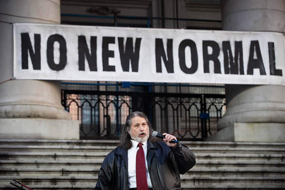Mark Donnelly, who has been the anthem singer for the Vancouver Canucks NHL hockey team since 2001, performs O Canada at a protest against measures taken by public health authorities to curb the spread of COVID-19, in Vancouver, B.C., Saturday, Dec. 5, 2020. THE CANADIAN PRESS/Darryl Dyck