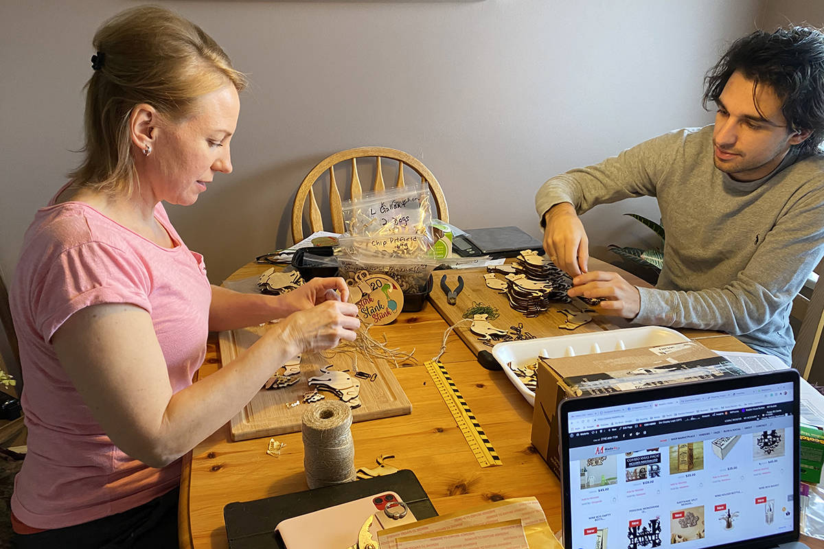 After Alanna Wadhwani, seen here with son Nathan, was deluged with orders for her ‘dog poo’ 2020 Christmas ornament, she set up what she described as a factory in her West Maple Maple Ridge home (Special to The News)