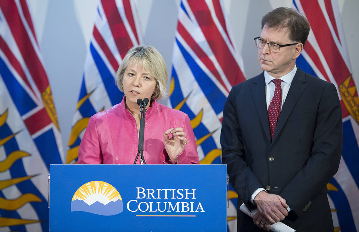 British Columbia Health Minister Adrian Dix looks on as Provincial Health Officer Dr. Bonnie Henry addresses the media during a news conference at the BC Centre of Disease Control in Vancouver B.C, Tuesday, January 28, 2020. THE CANADIAN PRESS/Jonathan Hayward