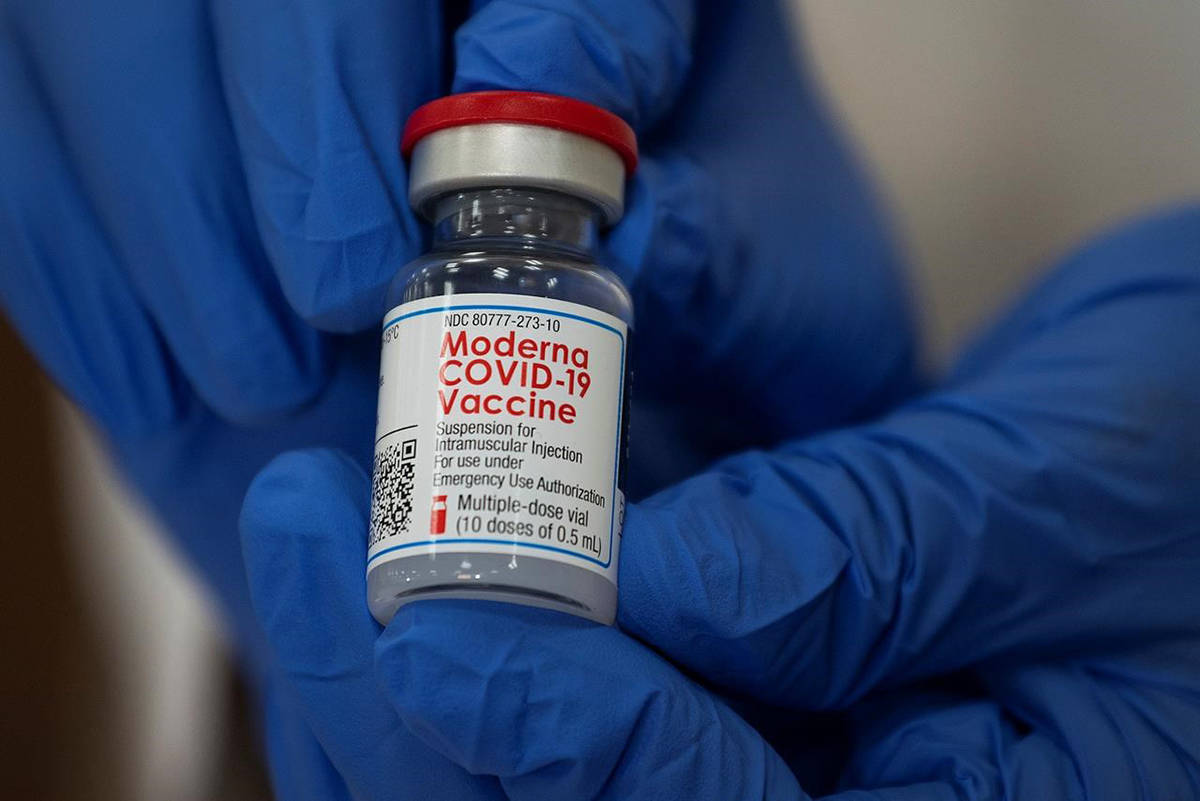 Michelle Chester, director of employee health services at Northwell Health, holds a bottle containing the Moderna COVID-19 vaccine at Northwell Health’s Long Island Jewish Valley Stream hospital in Valley Stream, N.Y., on Monday, Dec. 21, 2020. (THE CANADIAN PRESS/Eduardo Munoz/Pool via AP)