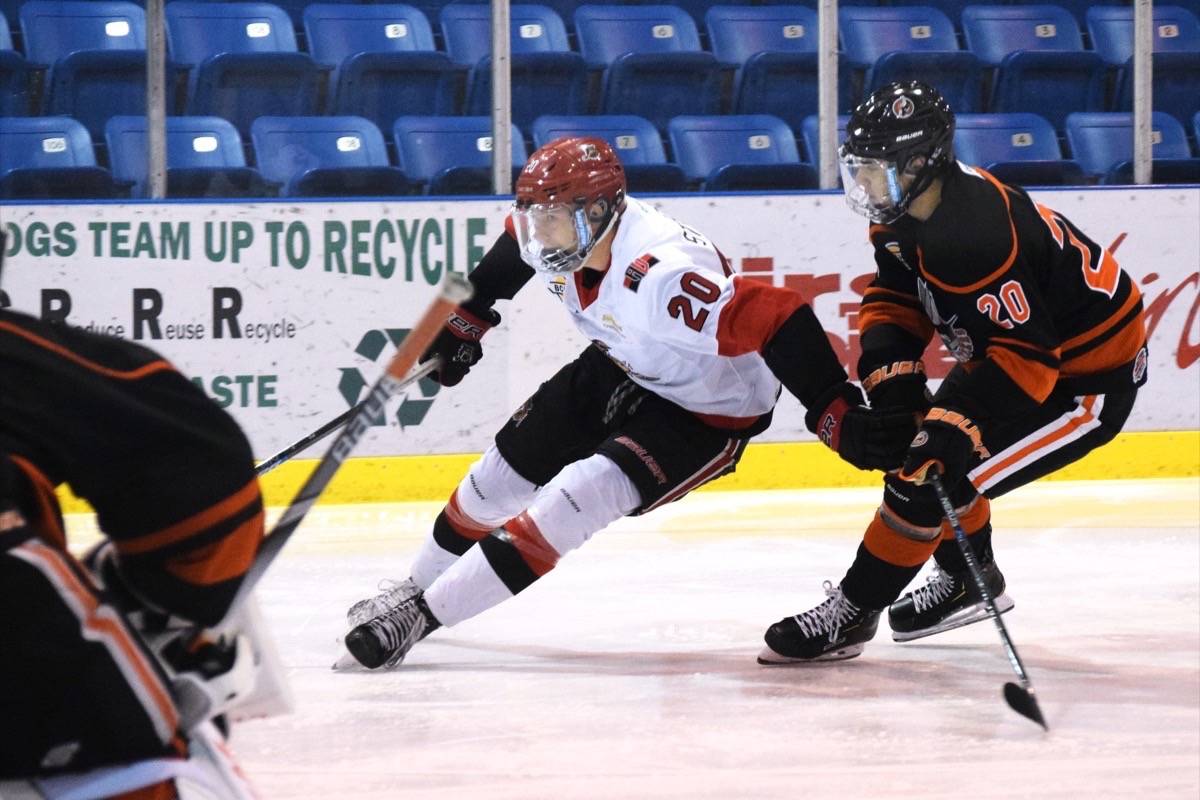 Bulldogs forward Caige Sterzer drives to the net, defended by his former teammate Moe Acee (now a Nanaimo Clipper). (ELENA RARDON / ALBERNI VALLEY NEWS)