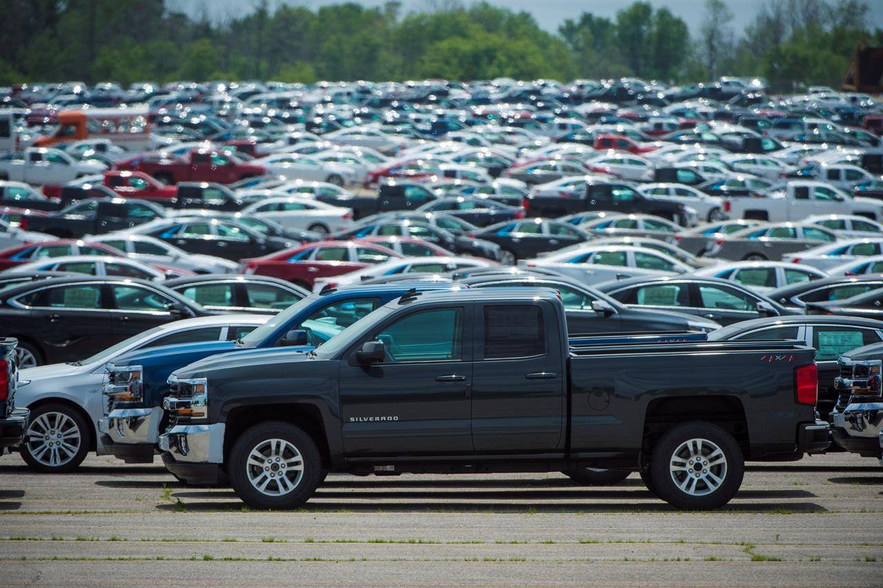 Vehicles are seen in a parking lot at the General Motors Oshawa Assembly Plant in Oshawa, Ont., on June 20, 2018. THE CANADIAN PRESS/ Tijana Martin
