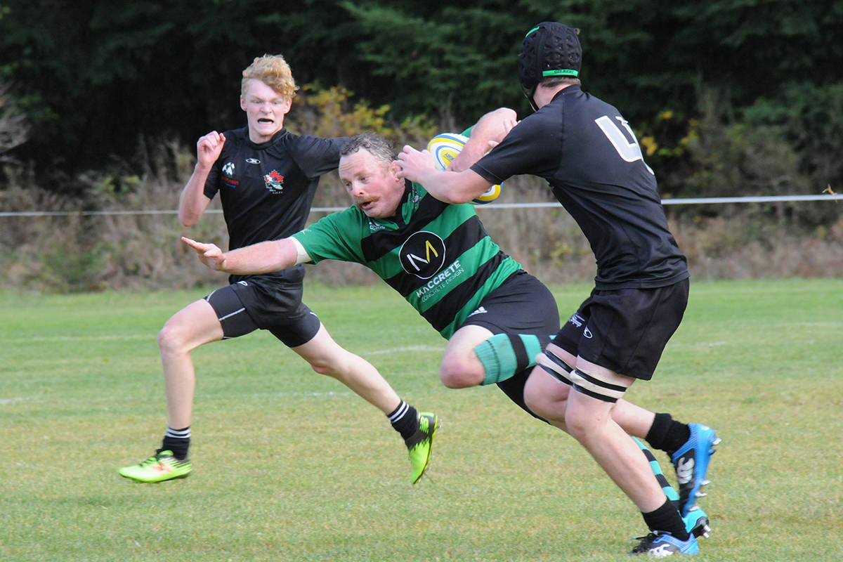 Port Alberni Black Sheep David Symington, left, and Conner Alexander chase down Cowichan Piggies’ Louis Gudmensmith during the Black Sheep’s home turf victory in Div. 1 men’s rugby action back in 2019. SUSAN QUINN PHOTO
