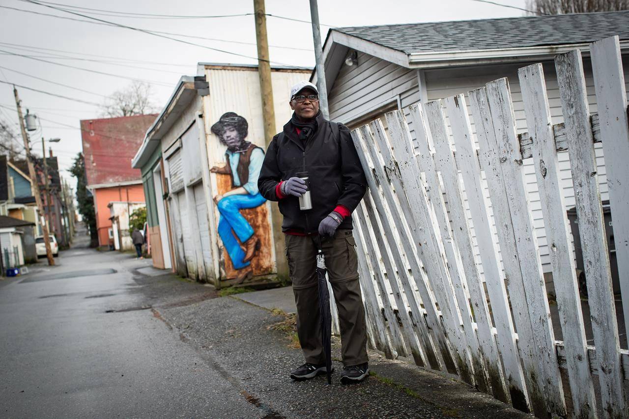 Lama Mugabo, a board member at the Hogan’s Alley Society, poses for a photograph at the remaining portion of Hogan’s Alley, in Vancouver, on Wednesday, January 27, 2021. The historic black neighbourhood was demolished to make way for the construction of the Georgia and Dunsmuir viaducts in the early 1970s. THE CANADIAN PRESS/Darryl Dyck