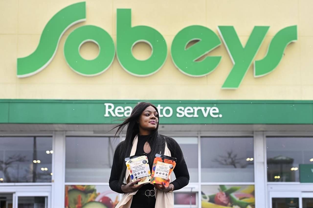 Lola Adeyemi, a Nigerian entrepreneur, poses with a few of her African soup products, which are now sold in Sobeys and other Canadian grocery retailers, in Toronto on Friday, February 5, 2021. THE CANADIAN PRESS/Nathan Denette