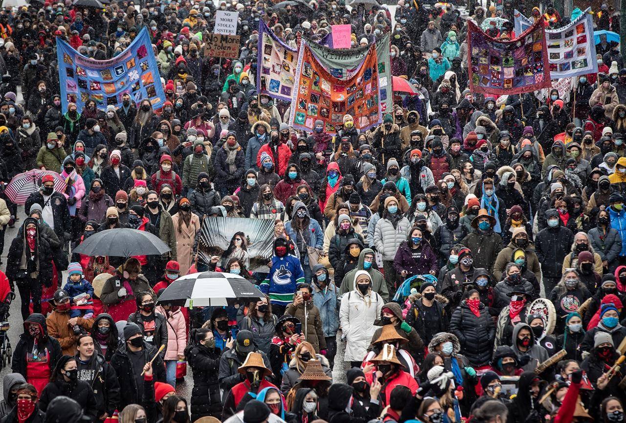 People participate in the annual Women’s Memorial March in Vancouver, B.C., Sunday, Feb. 14, 2021. The second wave of the COVID-19 pandemic did not stop a rising tide of reports of domestic violence, experts say, warning that the stress of life in lockdown continues to put victims at risk. THE CANADIAN PRESS/Darryl Dyck