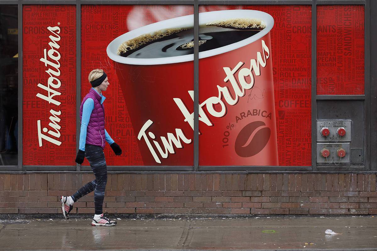 FILE – Signage for Tim Hortons is seen outside a Tim Hortons restaurant in Toronto, Friday, March 6, 2020. THE CANADIAN PRESS/Cole Burston