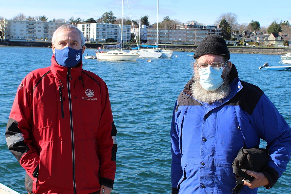 President Justin Stephenson of the Royal Canadian Marine Search and Rescue station in Oak Bay, and local sailor David Taggart, with Taggart’s 27-foot Catalina sailboat in the background. (Travis Paterson/News Staff)