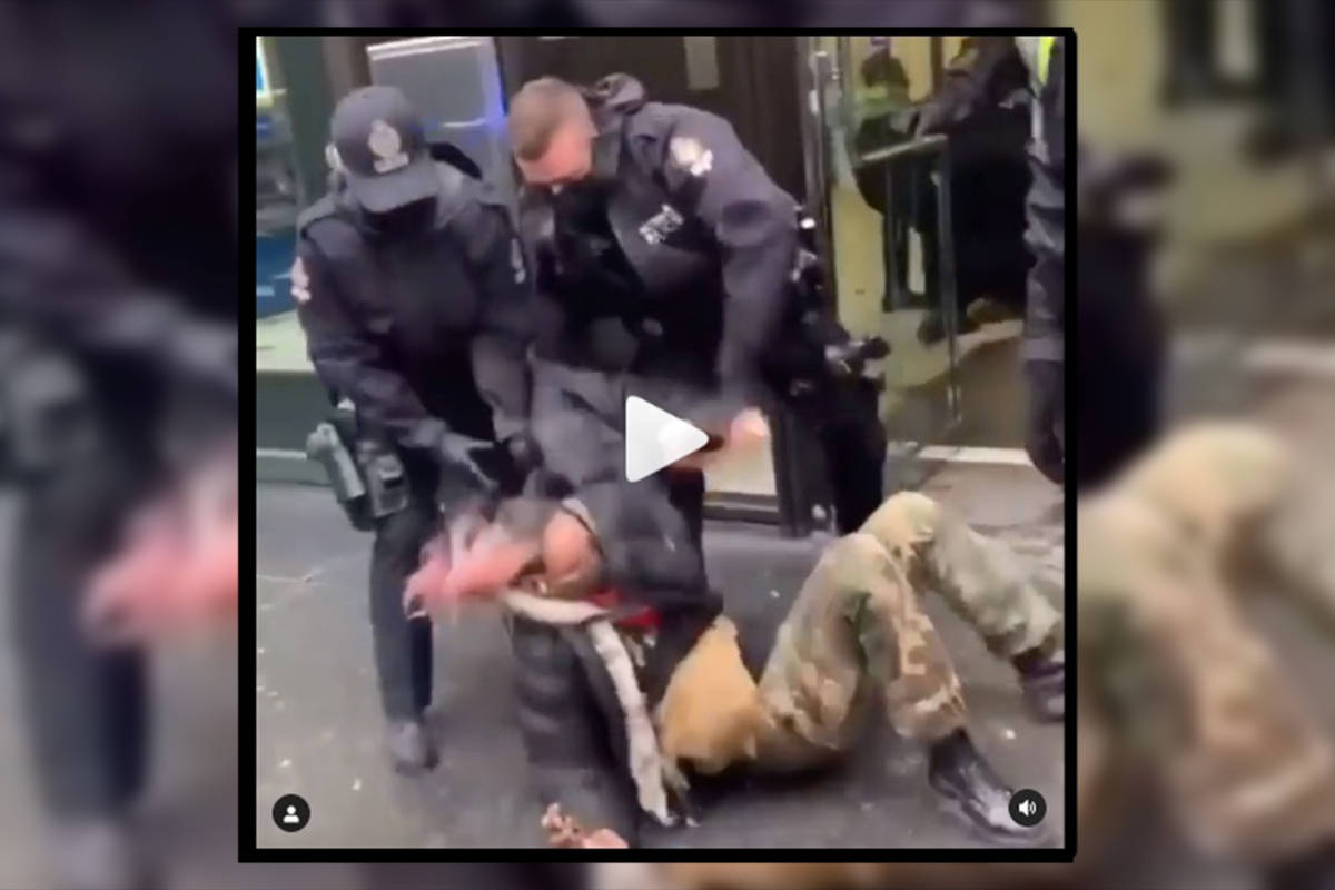 Screenshot from a video showing police removing protestors from the BMO building in Vancouver. (Instagram)