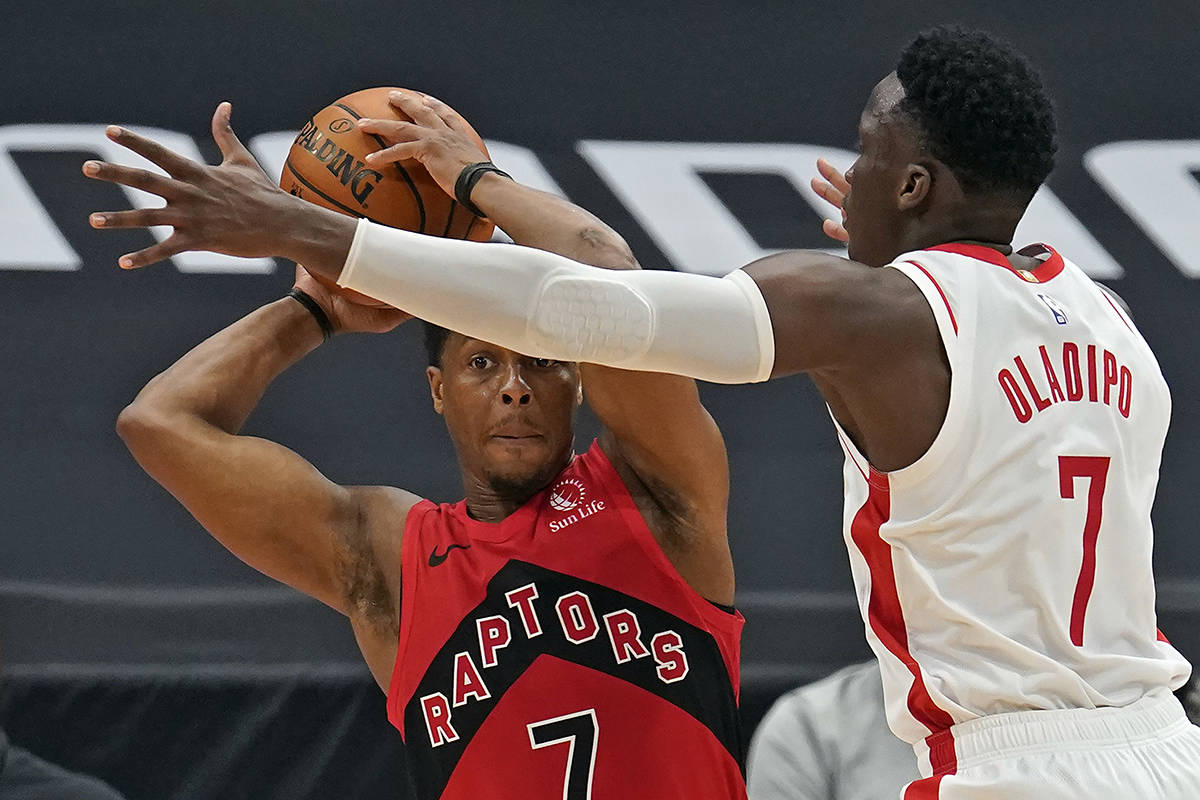 Houston Rockets guard Victor Oladipo, right, blocks a pass attempt by Toronto Raptors guard Kyle Lowry during the second half of an NBA basketball game Friday, Feb. 26, 2021, in Tampa, Fla. (AP Photo/Chris O’Meara)