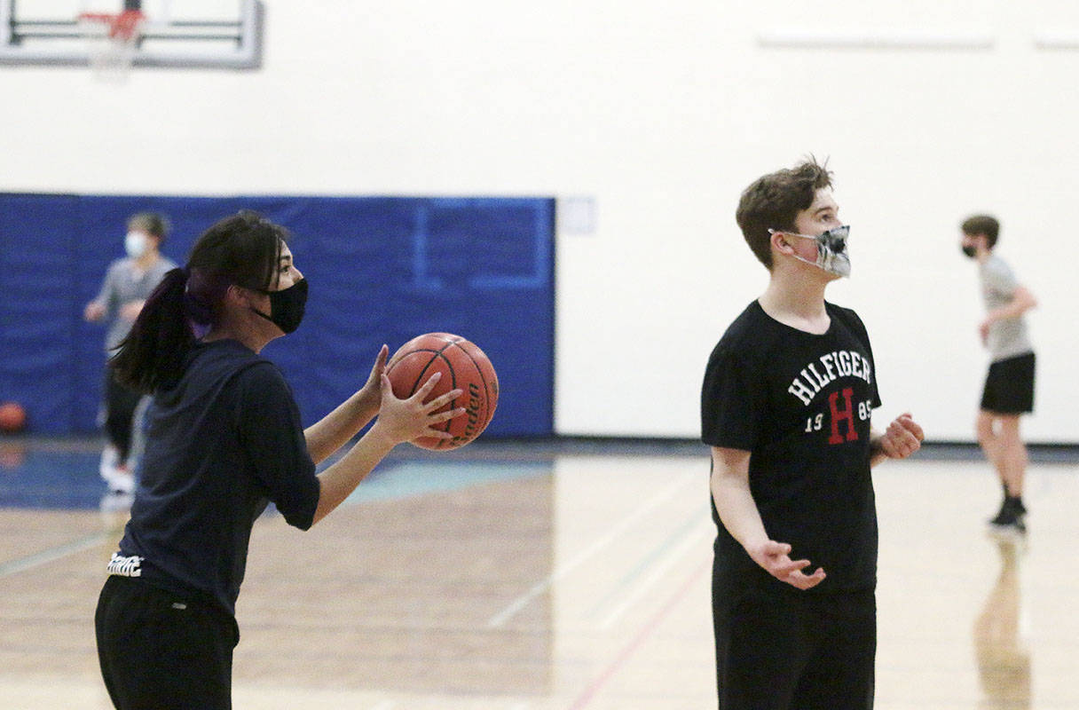 Duncan Christian’s Grace George lines up a shot during the three-point portion of the BC School Sports Pandemic Basketball Challenge after taking a pass from Cam Stevens. (Kevin Rothbauer/Citizen)