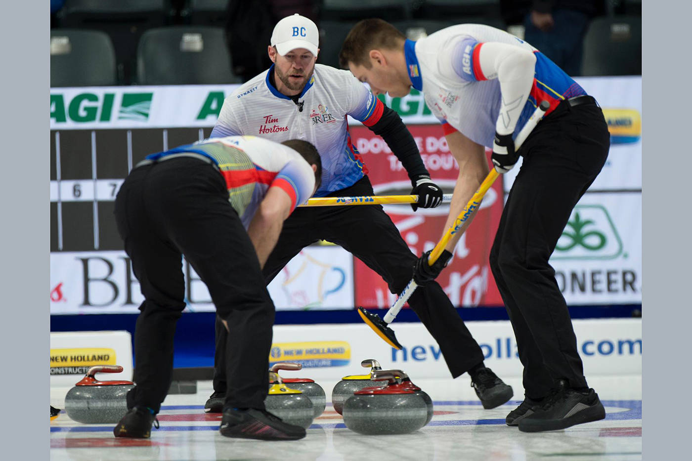 Vernon’s Jim Cotter (centre) and Kelowna’s Rick Sawatsky (left) and Andrew Nerpin follow a Steve Laycock shot into the house at the 2021 Tim Hortons Brier Canadian men’s curling championships in Calgary. (Michael Burns Photography)