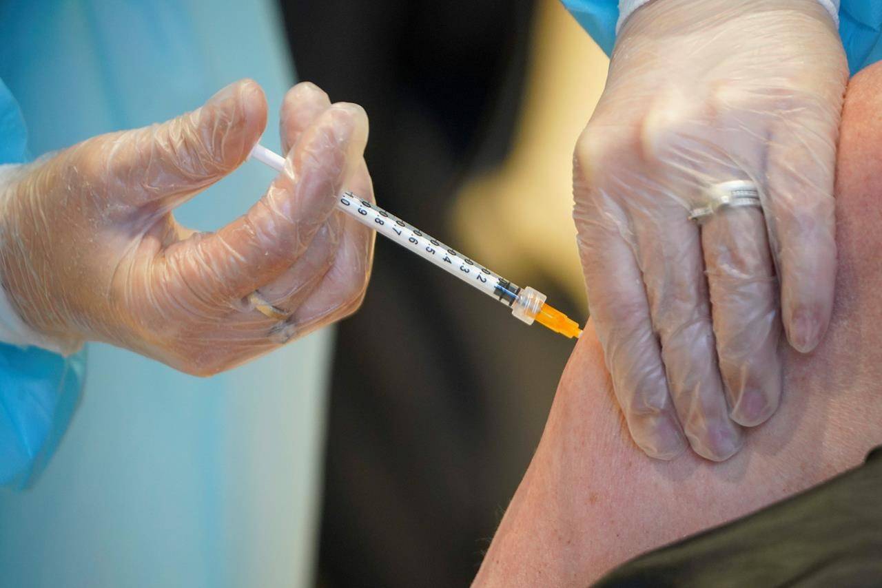 A health worker administers a dose of the AstraZeneca vaccine against COVID-19 to a patient inside the convention center known as “La Nuvola”, The Cloud, in Rome, Wednesday, March 10, 2021. The visually extraordinary complex designed by famed architect Massimiliano Fuksas has been transformed into a temporary vaccination center. (AP Photo/Andrew Medichini)