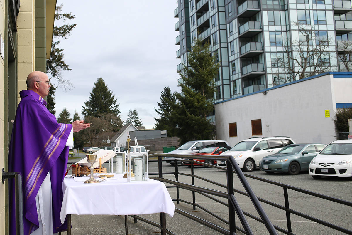 Members of Our Lady of the Rosary Catholic Church enjoyed mass from their vehicles Tuesday morning on Goldstream Avenue. (Dawn Gibson/News Staff)