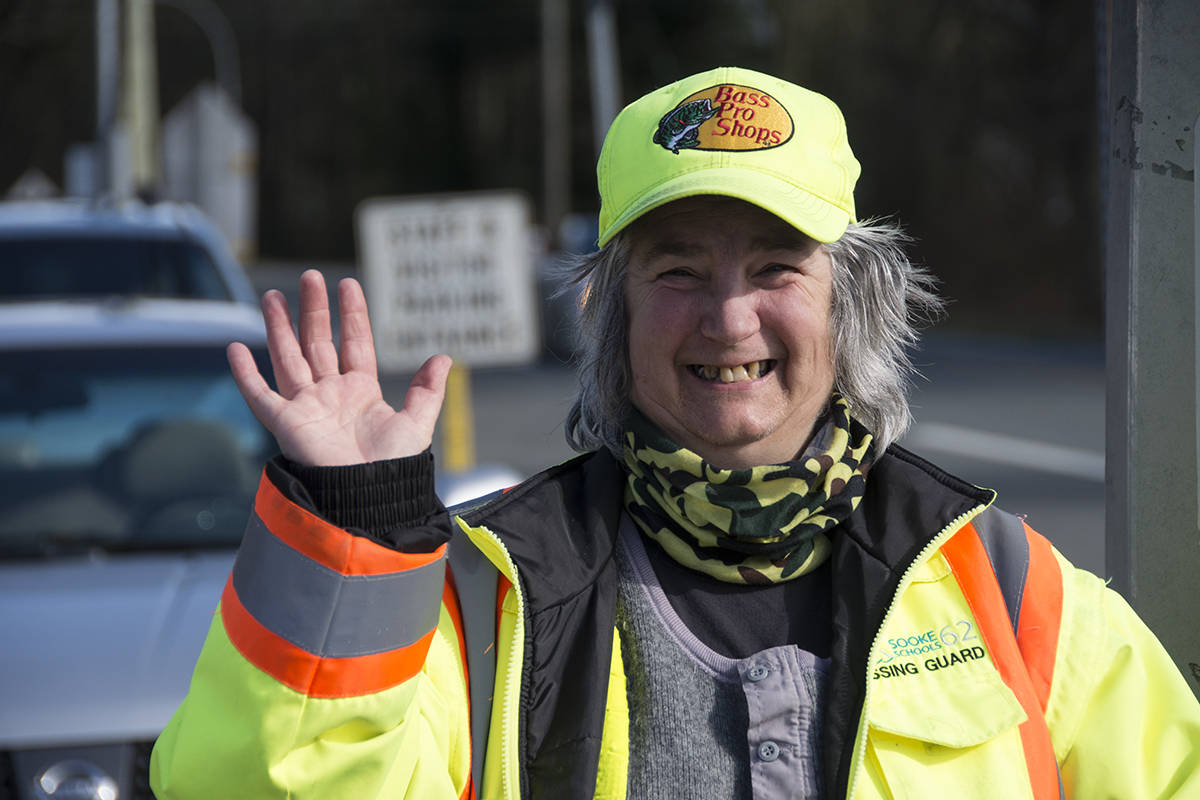 Crossing guard Sarah Ferrier at Saseenos Elementary School offers smiles and waves bringing joy to drivers and students alike. (Nina Grossman/News Staff)