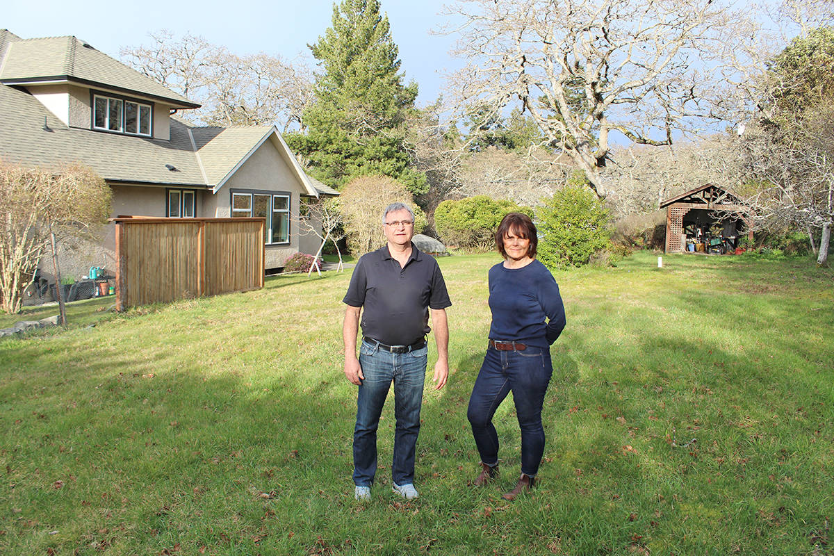 Rob and Anita Parris on the south side of their Island Road property. The couple had hoped to subdivide but have run into some significant costs. (Travis Paterson/News Staff)