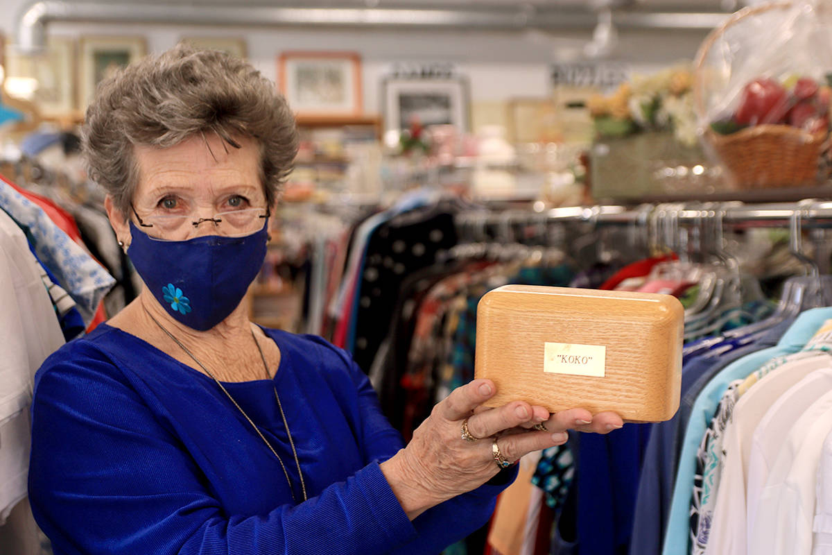 Grand Forks’ Lenora “Jo” Belazs holds up a box thought to contain the ashes of “Koko,” left at the Boundary Hospital Auxiliary Thrift Shop on Wednesday, March 24. Photo: Laurie Tritschler