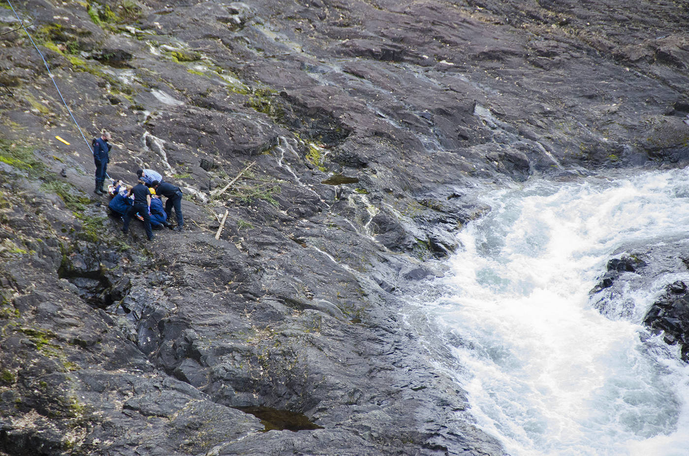 Campbell River Fire Rescue and BC Ambulance Service crews load an injured man into a basket stretcher on the rocks above Elk Falls on April 5. It’s believed the man slipped on the rocks and injured his leg, but the situation could have ended much more tragically, rescuers say. Photo by Mike Davies/Campbell River Mirror