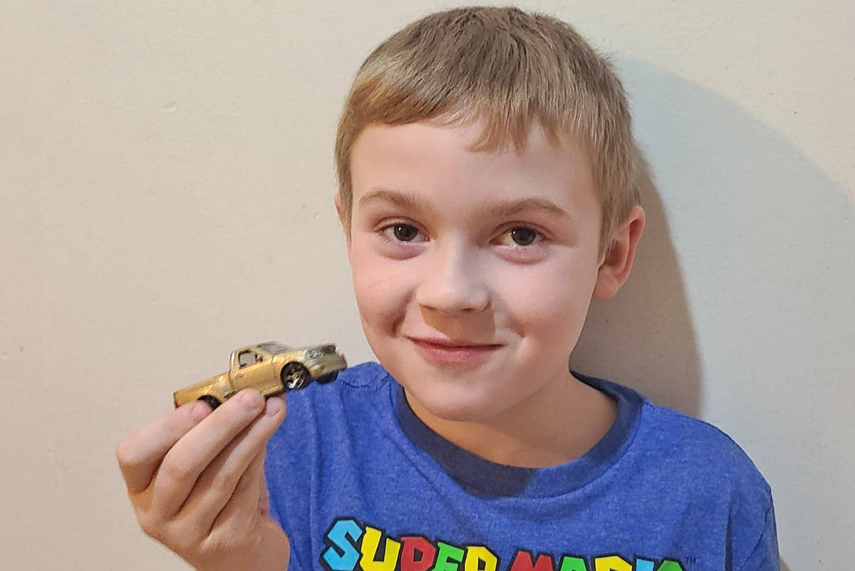 Tyson Ginter, 7, is proud of his latest Hot Wheels he recently received by Quesnel RCMP Const. Matt Joyce. (Photo submitted)